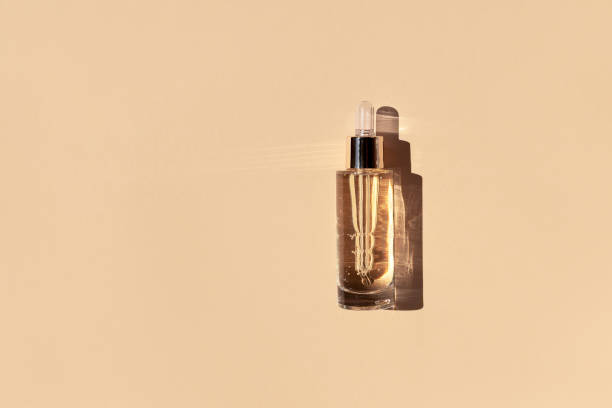 istock Glass bottle cosmetic serum beige background. 1327885806