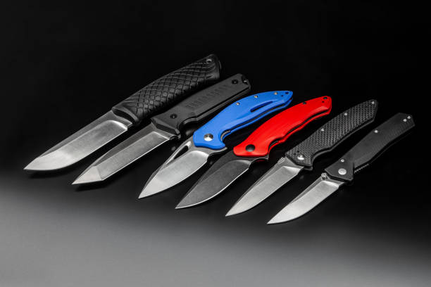 istock folding knives on a black background. pen knives on a dark background 1327885999