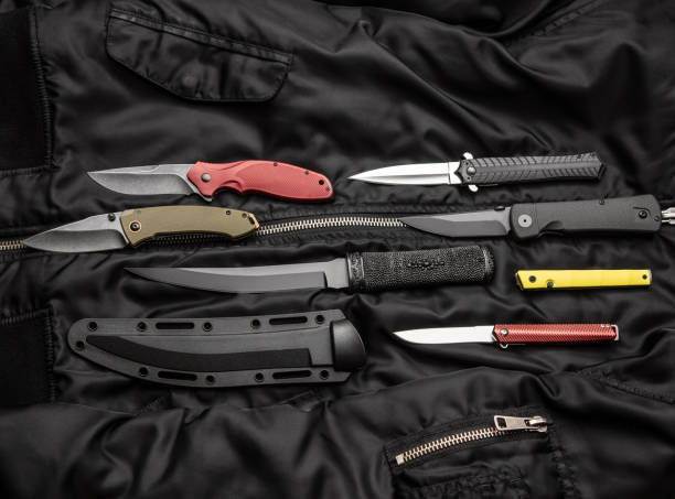 istock folding knives on a black background. pen knives on a dark background 1327886001
