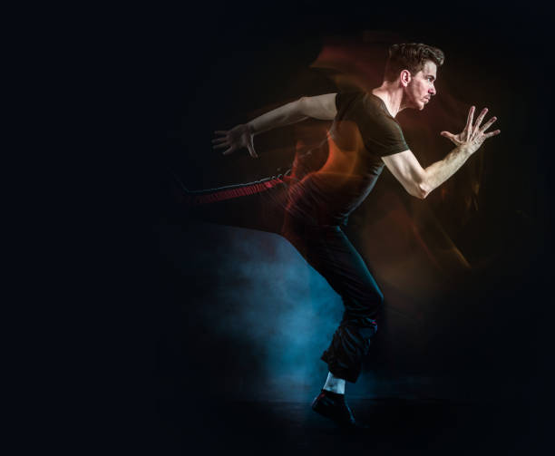 istock Athlete running on black background with smoke 1327886834