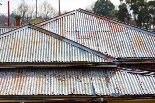 Closeup old damaged corrugated iron roof, background with copy space, full frame horizontal composition