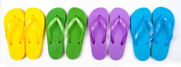 istock four pairs of multicolored rubber beach flip flops in a row on a white background, isolate 1327892585