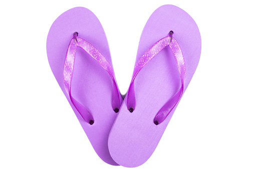 purple rubber beach flip flops on a white background, isolate, view from above.