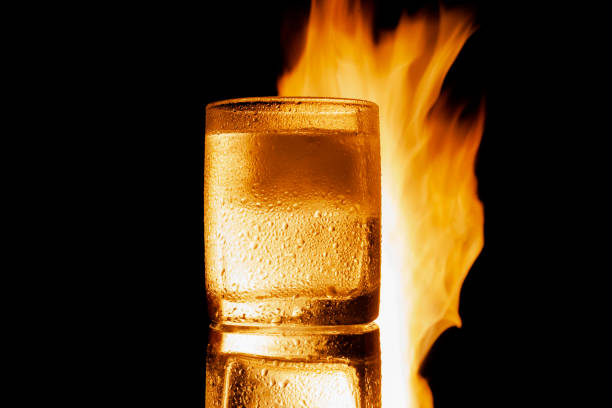 istock sweating glass of water on a black background, isolate 1327893282