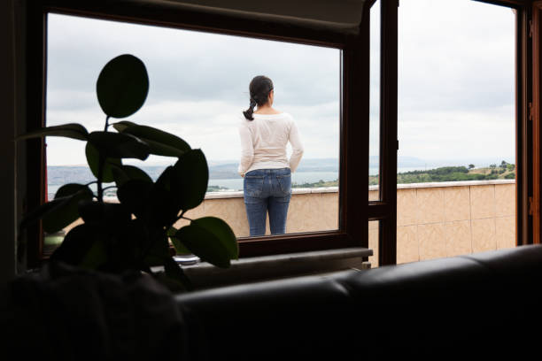 istock Woman standing and relaxing on balcony 1327894066
