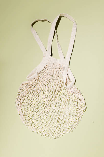 istock Reusable cotton shopping string bag on green background. Zero waste concept. No plastic 1327894982