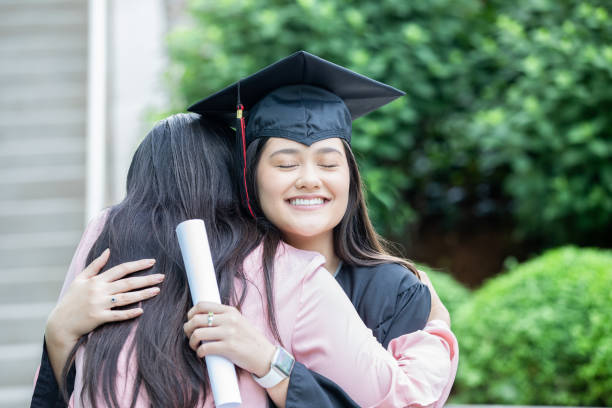 istock Mother and daughter hugging after graduation 1327897438