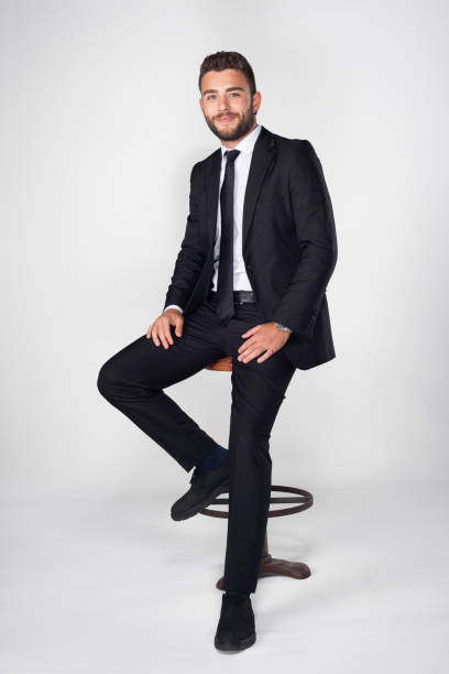 niño joven con barba y cabello castaño en traje posando para la foto sobre fondo blanco. - turkish ethnicity white black contemporary fotografías e imágenes de stock