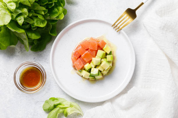 istock Salmon avocado tartare on white stone table background. 1327897939