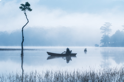 Fisherman in Tuyen Lam lake, Da Lat, Lam Dong province, central highlands vietnam