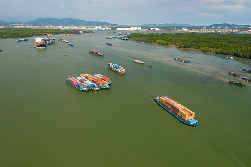 Drone view of heavy vessels shipping full of containers on riverfront of Ba Ria, south Vietnam