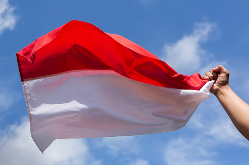 hand grab Indonesian Flag in the air
