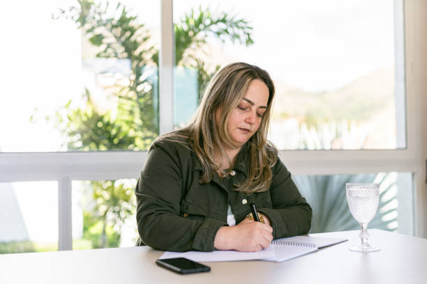 istock business woman signing documents 1327911134