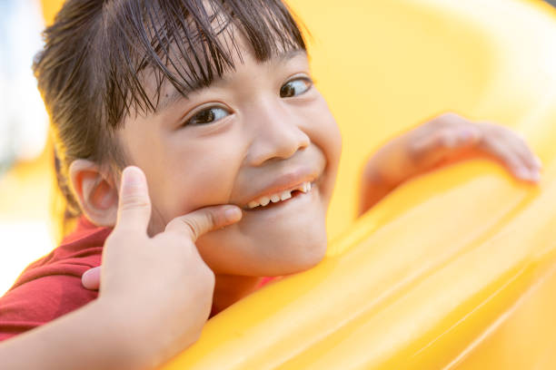 istock little girl showing her broken milk teeth 1327912196