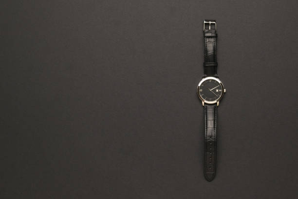 istock Stylish classic men's watch with hands on a black background. 1327913027