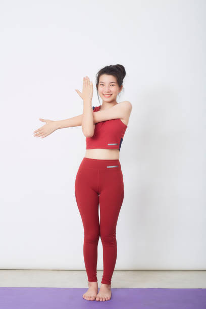 istock Young beautiful woman working out over light background 1327914937