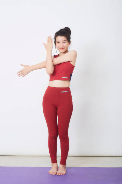 istock Young beautiful woman working out over light background 1327914987