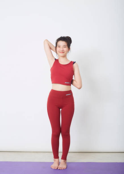 istock Young beautiful woman working out over light background 1327914989
