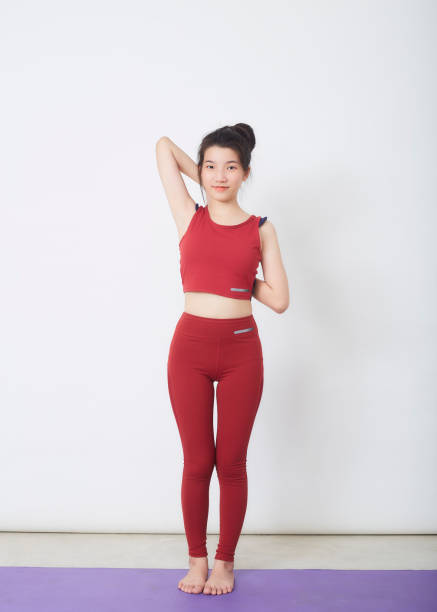 istock Young beautiful woman working out over light background 1327914999