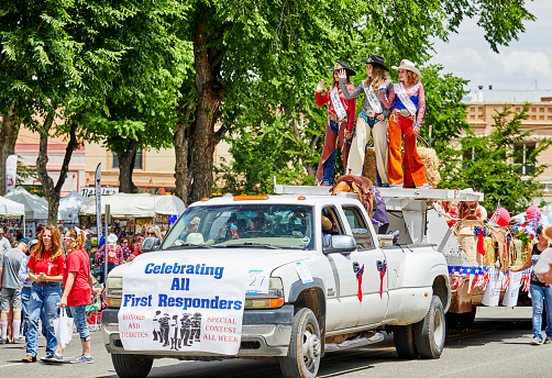 Prescott, Arizona, USA - July 3, 2021: Participants riding on a float and waving to the spectators in the 4th of July parade