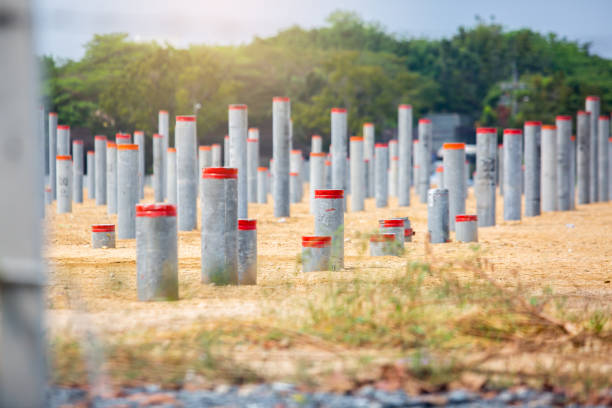 Selective focus to many round prestressed concrete piles that have been hammered into the ground in a large project. Concrete Pile for Foundation of Building. construction foundation work.