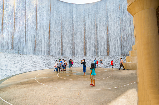 Houston, USA impressive Gerald D. Hines Waterwall Park with tourists visiting and photographing.