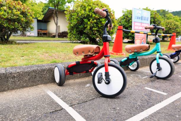 istock Two cute tricycles parked side by side in red and green 1327920641