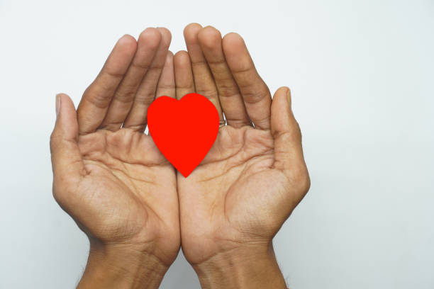 istock heart in hand caring heart concept on white background 1327920718