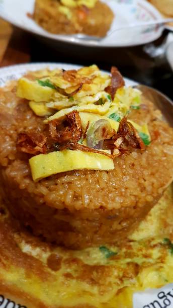 istock Delicious Indonesian fried rice topped with fried onion and fried egg 1327923050