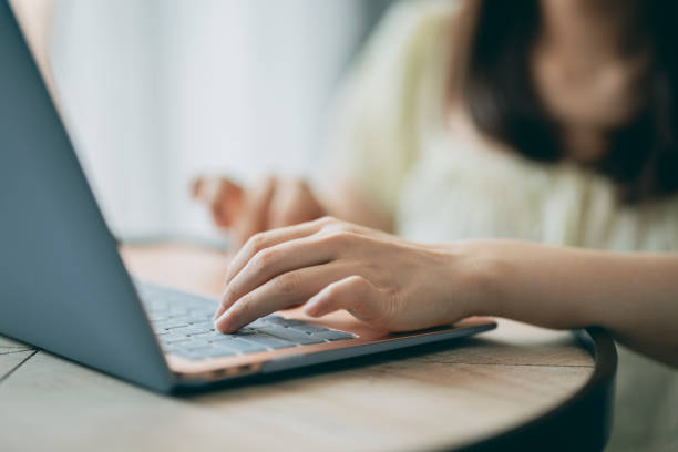 istock Young asian Woman using computer in living room 1327927124