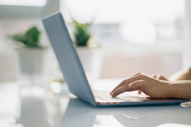 istock Young asian Woman using computer in living room 1327927130
