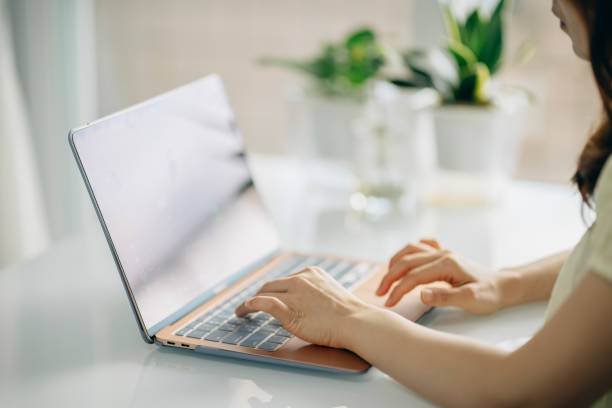 istock Young asian Woman using computer in living room 1327927131