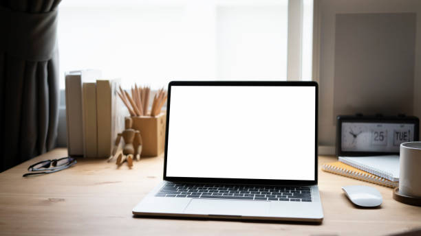 istock Mock up laptop and equipment on wooden table. 1327929708
