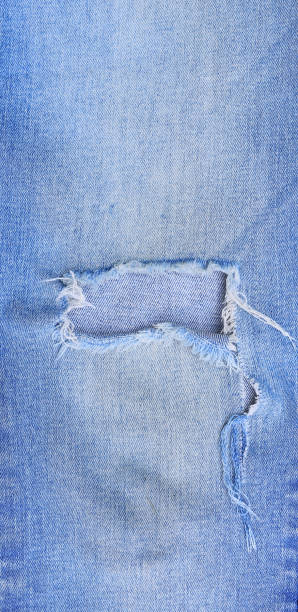 istock Close-up torn on blue Jeans background. Denim texture with detail 1327931766