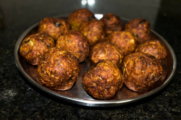 Indian Vegetarian koftas made with bottle gourd and gram flour as a main ingredients with onion, coriander leaf other ready for frying. stock photo