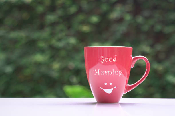 istock Good morning message on red coffee cup, on green nature background. 1327938821