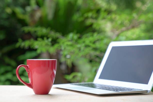 istock Good morning with coffee in red cup with computer laptop 1327938885