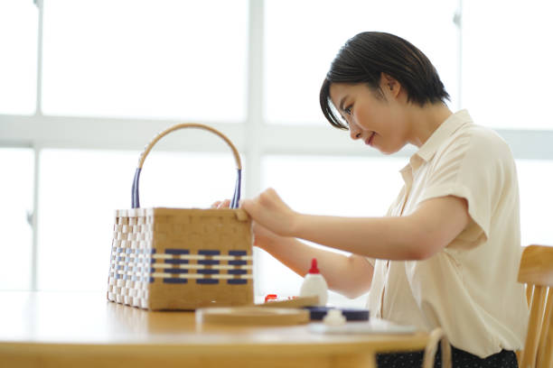 istock A woman making a basket with a craft band 1327939939