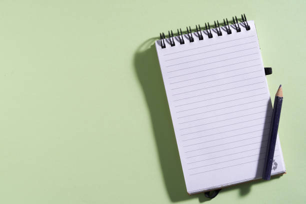 istock recycle note pad with short pencil on green background 1327940946