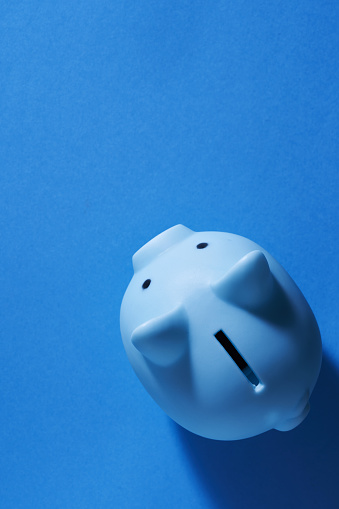 blue piggy bank on blue background