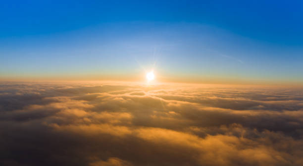 istock View from the drone at dawn over the clouds with mountains on the grassland. 1327941228