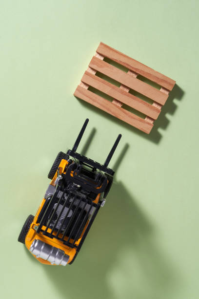 top view of toy forklift on green background