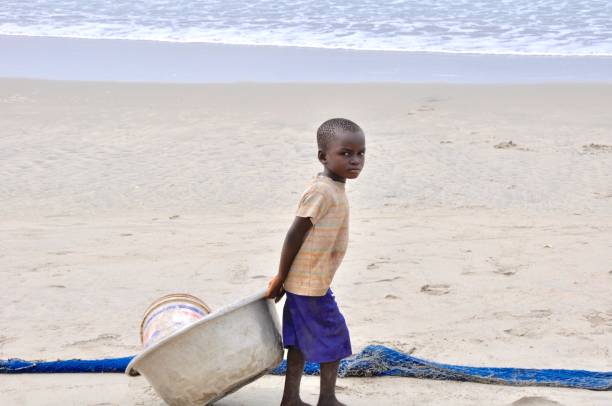 Photo of a young African American standing on the beach, flexing his muscles.  2013 iStockalypse L.A., California.