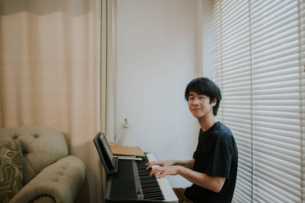 istock Nerd young boy look at camera before start his music performance - stock photo 1327947178