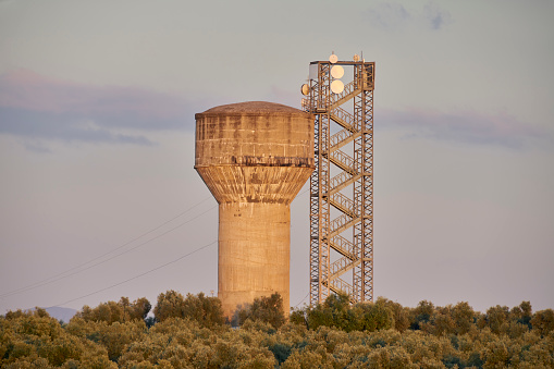 Water tank at sunset built of concrete in height in Mollina, Malaga. Spain