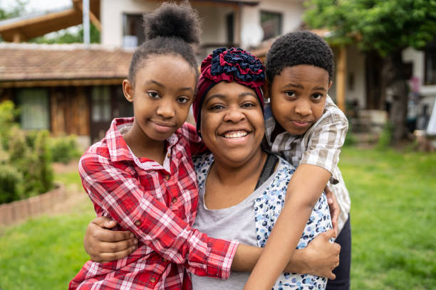 istock A single mother with two children looking at camera and smiling 1327949193