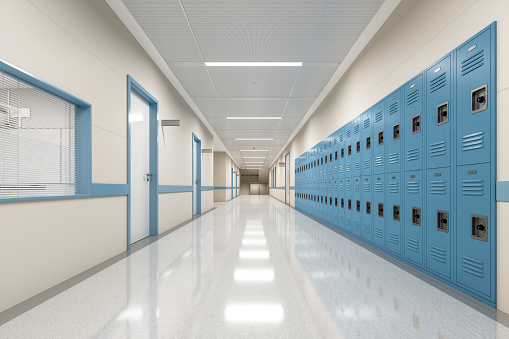 An empty school hallway with row of lockers.