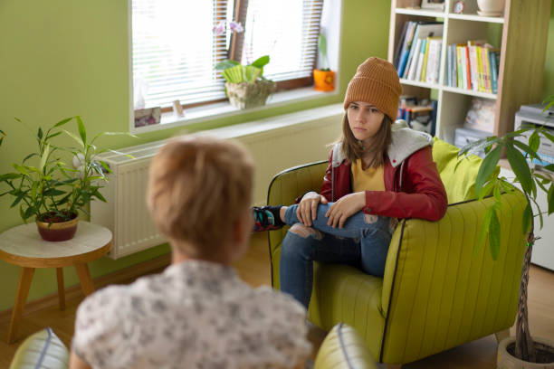 Unhappy young girl at the psychologist Young woman visiting therapist counselor. Girl feeling depressed, unhappy and hopeless, needs assistance. Serious disease, unwilling pregnancy, abort or death of loved one, addiction to drugs concept eating disorder stock pictures, royalty-free photos & images