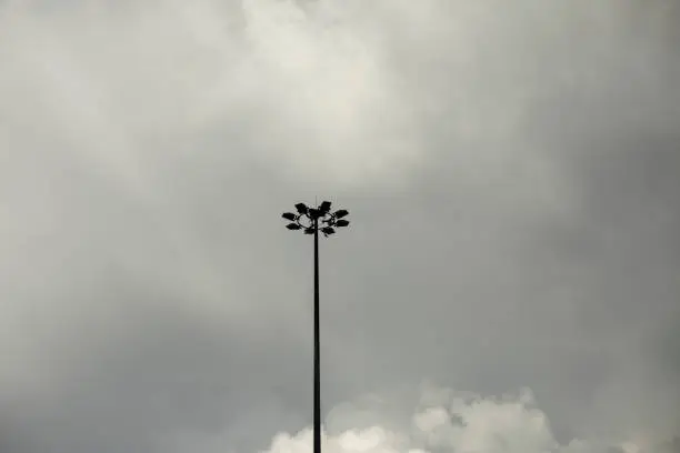 Photo of A fan pole against a grey sky.