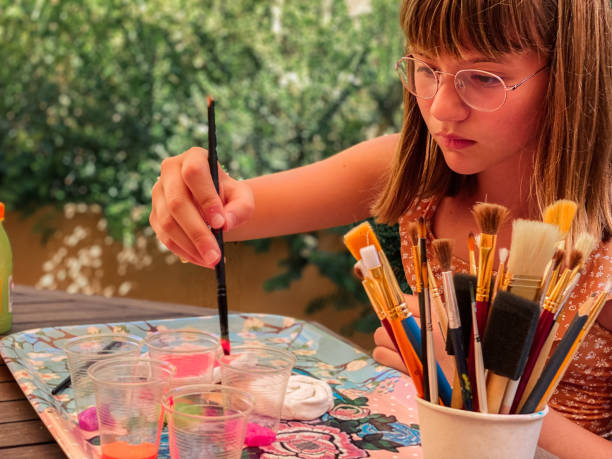 istock Girl doing crafts at home 1327952180